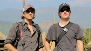 Craid and Brent Renaud stand outside, staring into the distance