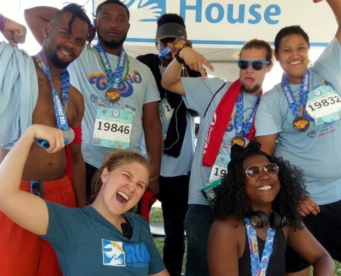 group of young people celebrating post-race