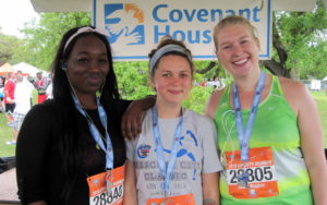 Three young women participating in the crescent city classic.