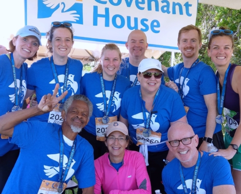 2019 team throwing up the peace sign at post-race fest