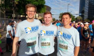 Three male runners wearing Covenant House t-shirts.