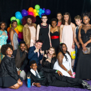 Covenant House Youth in suits and dresses at 2019 Pride Prom with an assortment of rainbow balloons in the backdrop.