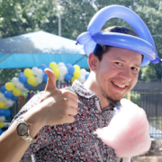 Man poses with cotton candy during Cov Carnival 2019