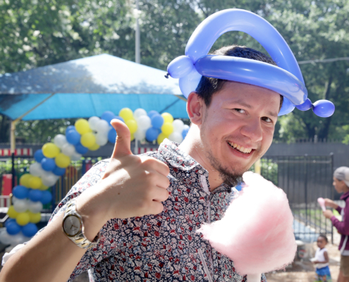 Man poses with cotton candy during Cov Carnival 2019