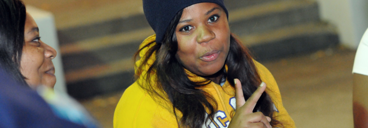 Covenant House resident gives peace sign to camera