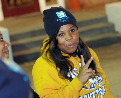 Covenant House resident gives peace sign to camera