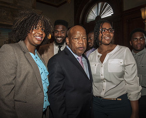 Rev. John Lewis standing in between two people