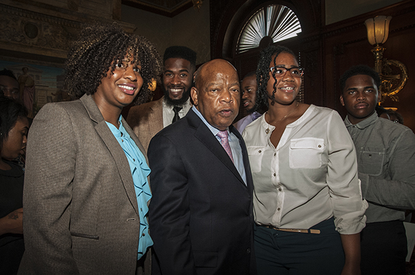 Rev. John Lewis standing in between two people