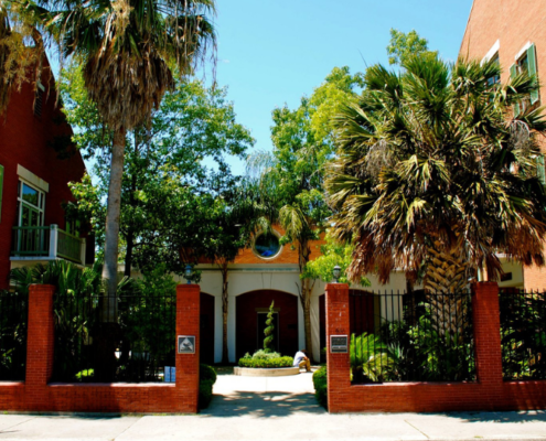 Front gates and courtyard of Covenant House New Orleans on a sunny day.